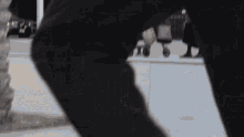 a person 's legs are shown in a blurry photo while walking down a sidewalk