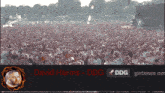 a large crowd of people are gathered in a field with the name david harms on the bottom