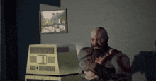 a man with a beard is sitting in front of a computer