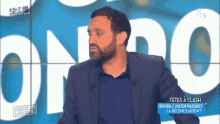 a man with a beard is standing in front of a screen that says u24 on it