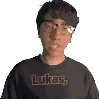 a young man wearing glasses and a black shirt that says lukas