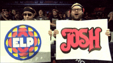 a couple of people holding up signs that say josh and elp