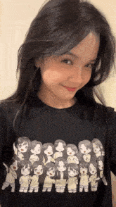 a girl wearing a black t-shirt with a group of cartoon girls on it