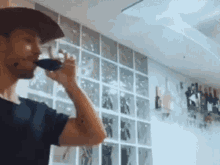 a man is drinking a glass of wine in a kitchen