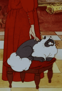 a woman in a red dress standing next to a cat on a stool