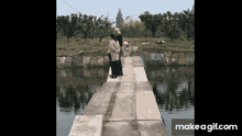 a couple standing on a bridge over a body of water