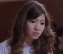 a close up of a woman 's face with long hair .