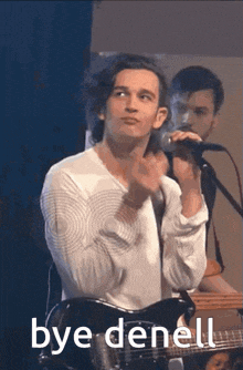 a man singing into a microphone with the words bye denell written on the bottom