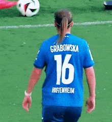 a female soccer player wearing a blue jersey with the number 16 on the back
