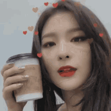 a woman holding a cup of coffee with hearts around her head