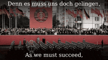 a crowd of people are gathered in front of a large red banner that says " denn es muss uns doch gelingen "