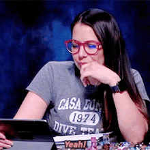 a woman wearing glasses and a t-shirt that says yeah on it