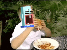 a man is sitting at a table with a plate of food and a toy on his face ..