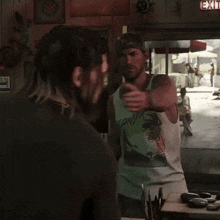 a man wearing a tank top that says kendra on it