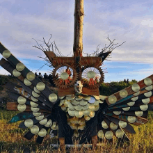 a sculpture of an owl made of tin cans