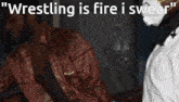 a close up of a gun with the words " wrestling is fire i swear " on the bottom