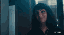 a woman talking on a cell phone with a netflix logo on the bottom right