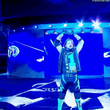 a wrestler wearing a vest that says aj style