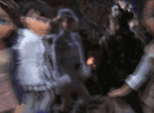 a blurred image of a group of people standing in a room