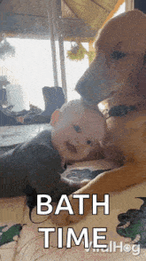 a baby laying next to a dog that says bath time on it