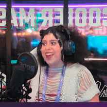 a woman wearing headphones is smiling in front of a microphone that says 300b