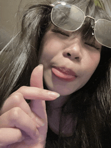 a woman wearing sunglasses and making a funny face
