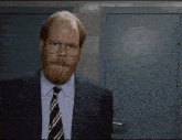 two men are standing next to each other and one has a beard