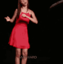 a woman in a red dress is standing in a dark room with mayward written on the bottom