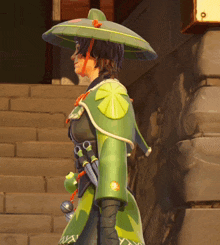 a person wearing a green umbrella and a green jacket with the letter y on it