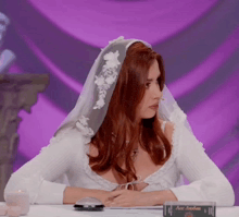 a woman in a wedding dress sits at a table with a card that says ace anderson