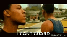 two men are standing next to each other on a bus and one of them is saying `` i can 't guard '' .