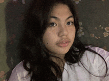 a close up of a girl 's face with a floral background