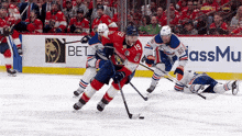 a hockey game is being played in front of an advertisement for ass mu