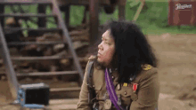 a man in a military uniform is sitting in front of some stairs and a sign that says premier