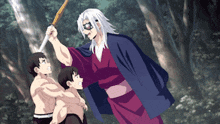 a man in a kimono is holding a sword and standing next to two boys .