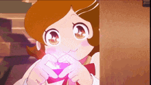 a cartoon girl is making a heart with her hands