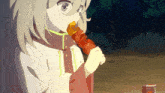 a girl is eating a skewer with a can of soda in the foreground