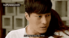 a man in a white shirt is talking to a woman and says i 'm going to lose my mind .