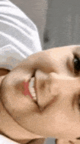 a close up of a person 's face with a smile on it