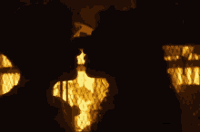 a silhouette of a man and woman kissing in front of a window .
