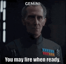 a man with a serious look on his face says " gemini : you may fire when ready "