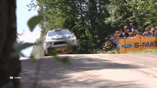 a ford advertisement is behind a car on a race track