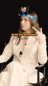 a woman wearing a headband that says ana de armas
