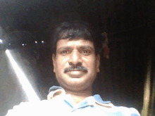 a man with a mustache is taking a picture of himself