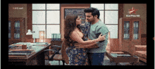 a man and a woman are hugging in a room with a star plus hd logo