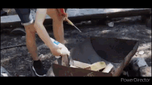 a person is using a lighter to light a fire .