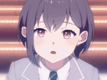 a close up of a girl with short hair and a surprised look on her face