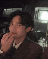 a man in a suit and tie is licking his lips