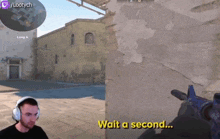 a man wearing headphones is playing a video game with the words wait a second