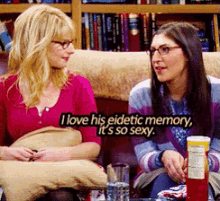 two women sitting on a couch with one saying " i love his eidetic memory "